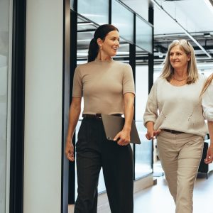 Three,Cheerful,Businesswomen,Walking,Together,In,An,Office.,Diverse,Group